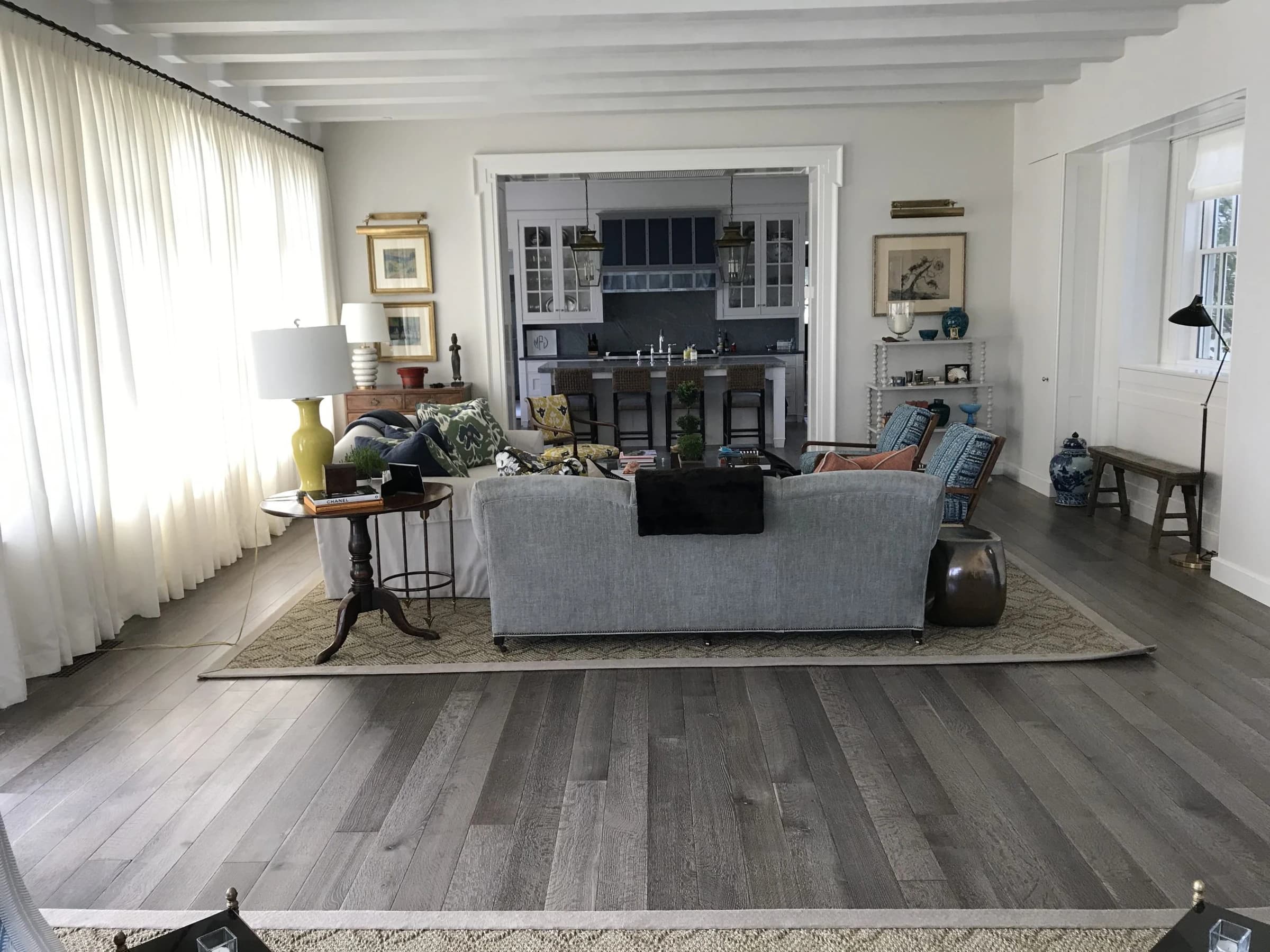 Wide wood boards leading into a bright, furnished living room from Ace’s project archive